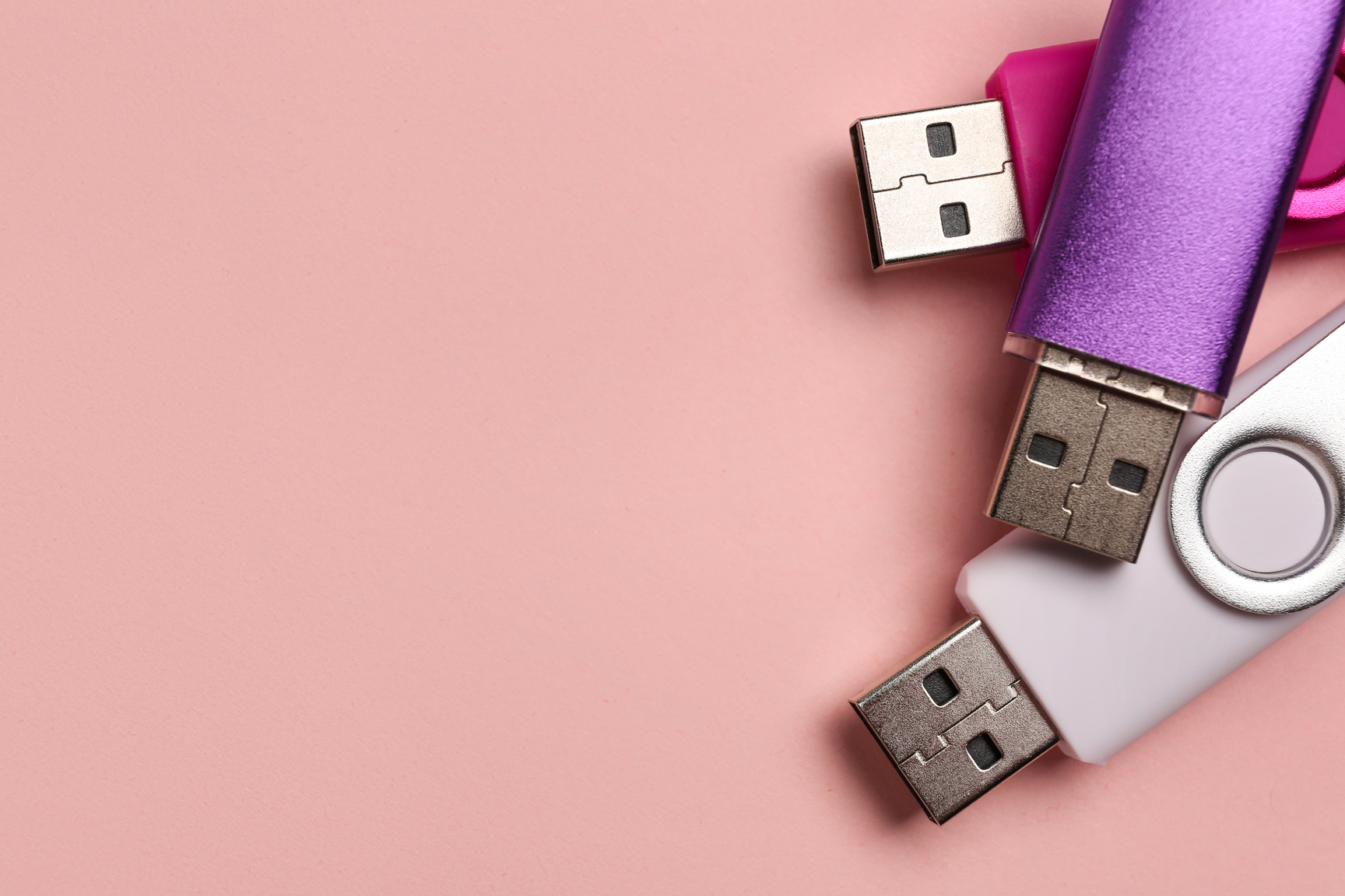 USB Flash Drives on Pink Background